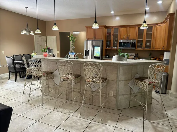 a large kitchen with a table and chairs