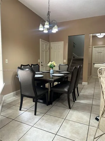 a dining room with furniture and chandelier