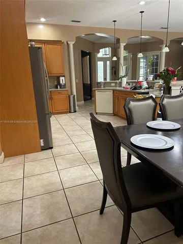 a dining room with furniture and window