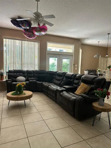 a living room with furniture and a chandelier
