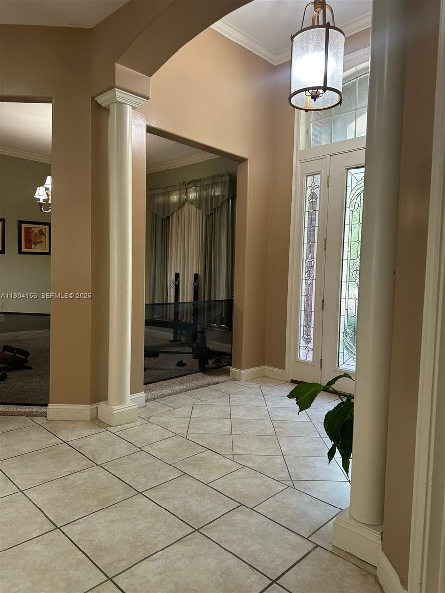 800 Permento Avenue Jacksonville, FL 32221 - Photo 19 of 29 a view of a hallway with wooden floor windows and a chandelier