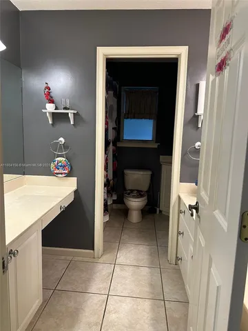 a bathroom with a sink a toilet and a shower
