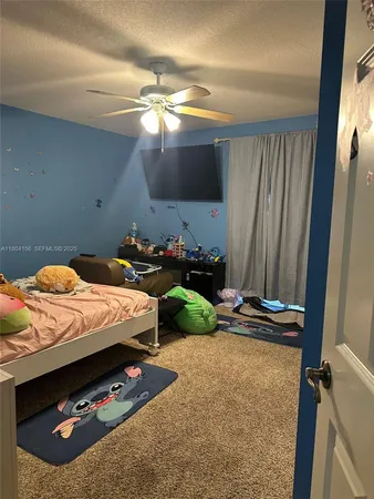 a bedroom with a bed a dresser and a mirror