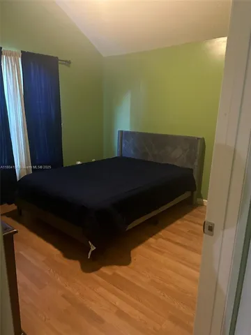 a bed sitting in a bedroom next to a small yard