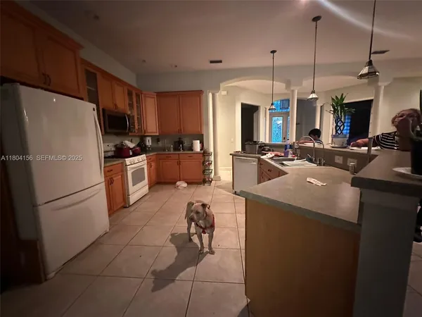 a kitchen with sink refrigerator and cabinets