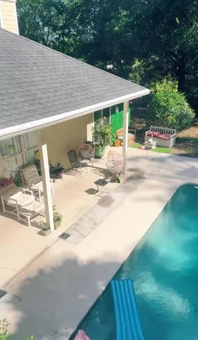 a view of a patio with a table and chairs under an umbrella