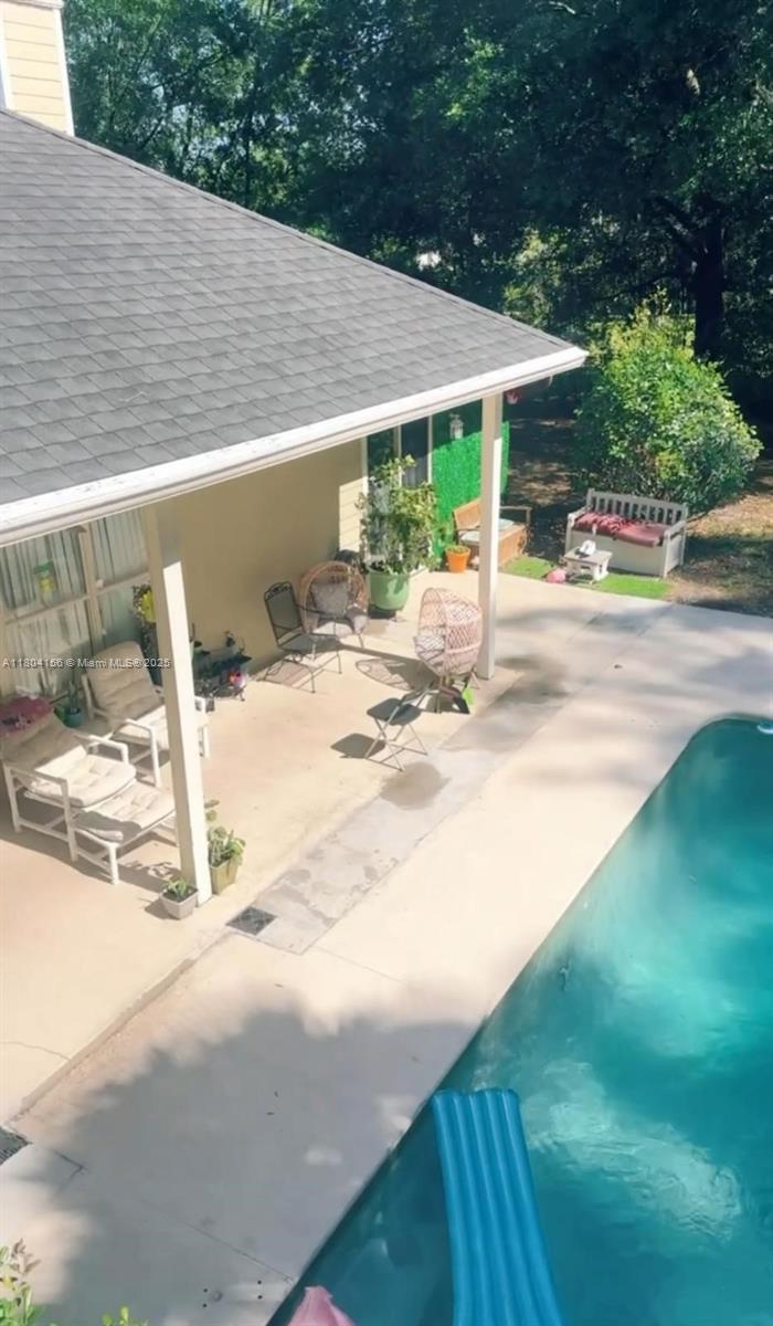 800 Permento Avenue Jacksonville, FL 32221 - Photo 8 of 29 a view of a patio with a table and chairs under an umbrella