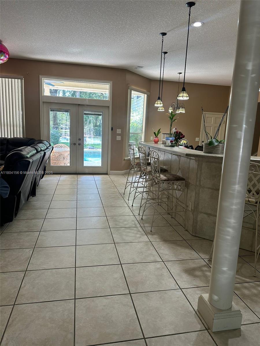 800 Permento Avenue Jacksonville, FL 32221 - Photo 9 of 29 a kitchen with granite countertop a rug a stove a counter top space and a window