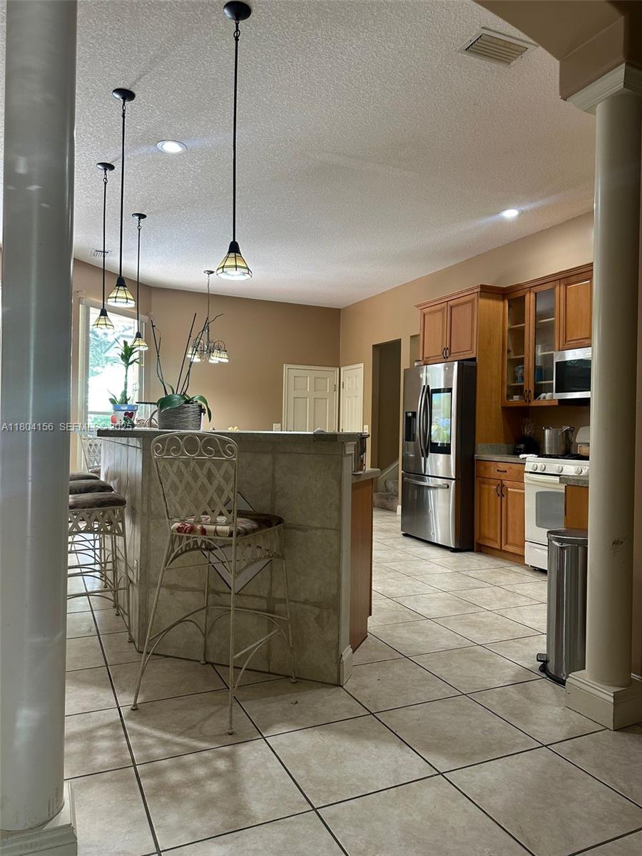 800 Permento Avenue Jacksonville, FL 32221 - Photo 10 of 29 a kitchen with stainless steel appliances granite countertop a refrigerator and a stove top oven