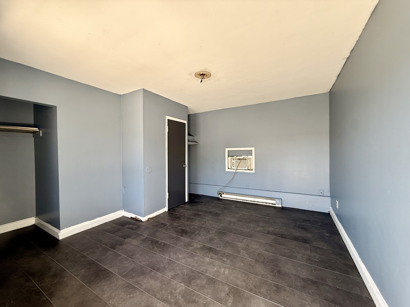 901 Highway 10 Clinton, IL 61727 - Photo 6 of 16 an empty room with wooden floor and windows