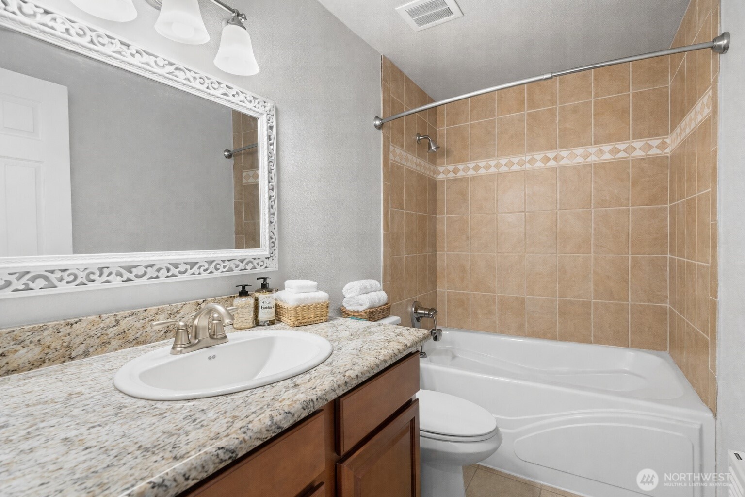 17303 Spanaway Loop Road South, Unit 2 Spanaway, WA 98387 - Photo 9 of 25 a bathroom with a granite countertop sink a toilet and shower
