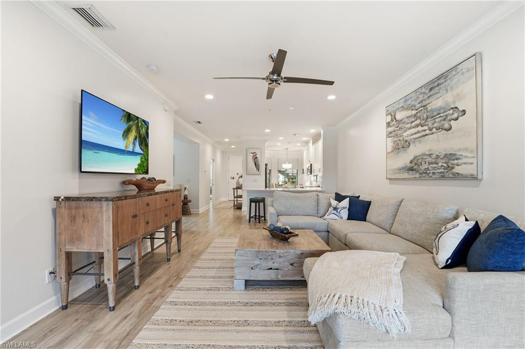 9426 Benvenuto Court, Unit 2104 Naples, FL 34119 - Photo 10 of 45 a living room with furniture and a flat screen tv