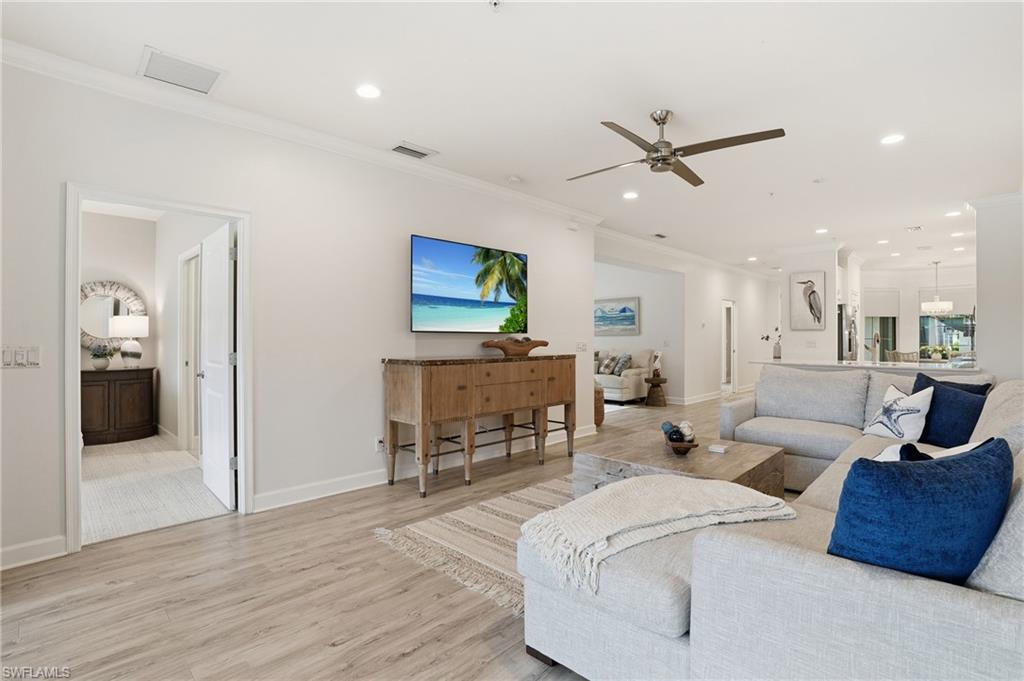 9426 Benvenuto Court, Unit 2104 Naples, FL 34119 - Photo 11 of 45 a living room with furniture and a wooden floor