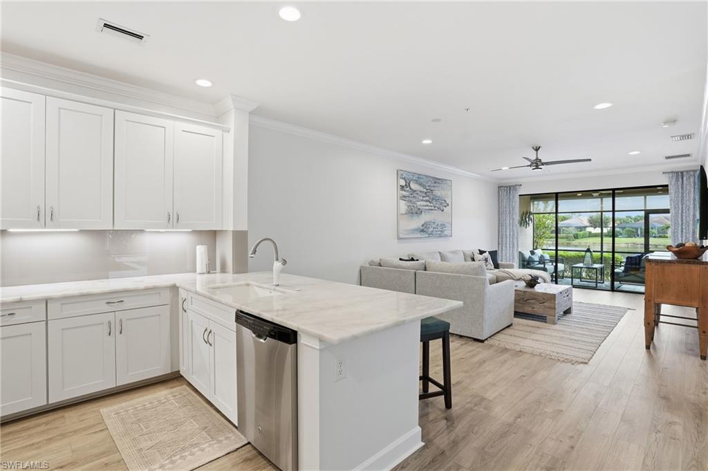 9426 Benvenuto Court, Unit 2104 Naples, FL 34119 - Photo 13 of 45 a view of a kitchen counter top space with sink stainless steel appliances and cabinets