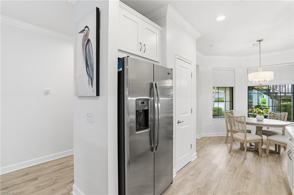 9426 Benvenuto Court, Unit 2104 Naples, FL 34119 - Photo 14 of 45 a kitchen with stainless steel appliances a refrigerator and a table