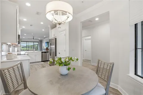 a kitchen with stainless steel appliances a refrigerator and a table