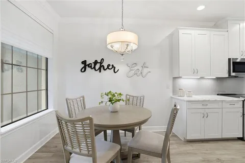 a kitchen with stainless steel appliances granite countertop a sink dishwasher a stove and a refrigerator with wooden floor