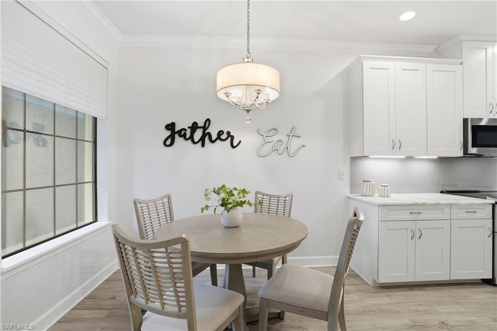 9426 Benvenuto Court, Unit 2104 Naples, FL 34119 - Photo 16 of 45 a dining room with furniture and window