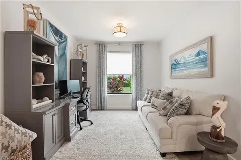a dining room with furniture and a chandelier