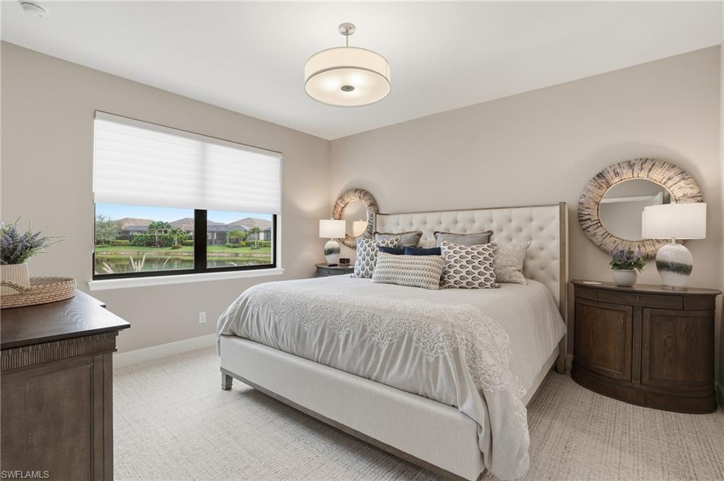 9426 Benvenuto Court, Unit 2104 Naples, FL 34119 - Photo 19 of 45 a bedroom with a large bed and a window