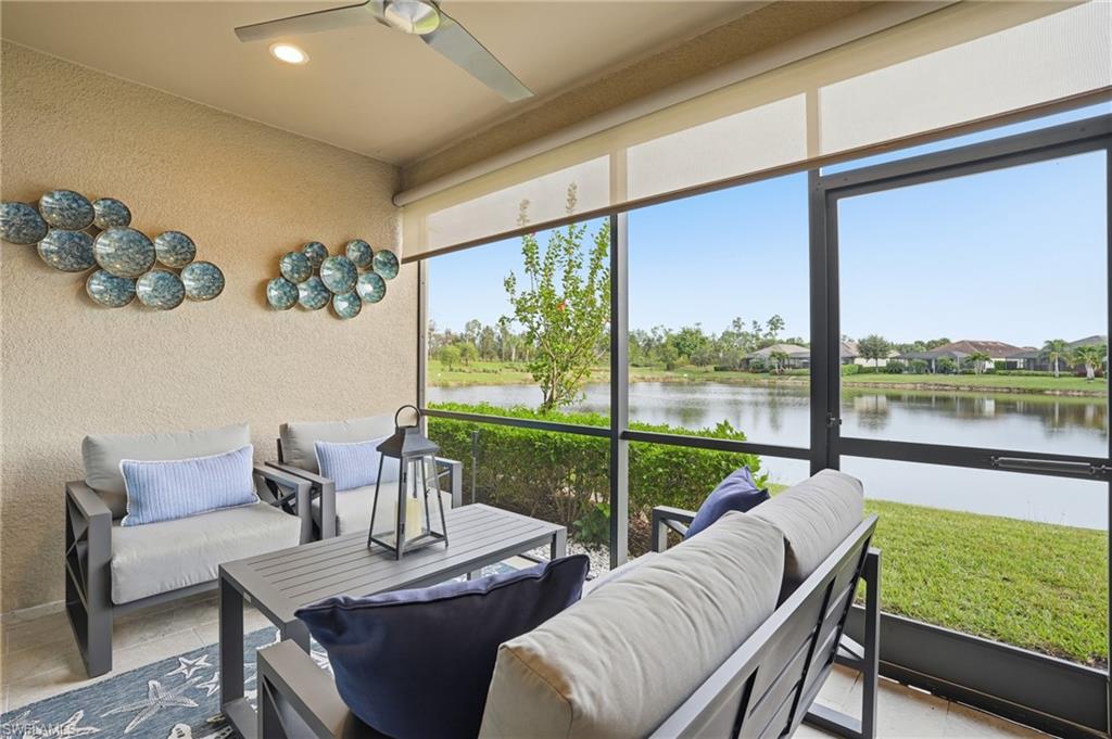 9426 Benvenuto Court, Unit 2104 Naples, FL 34119 - Photo 25 of 45 a living room with patio furniture and a floor to ceiling window
