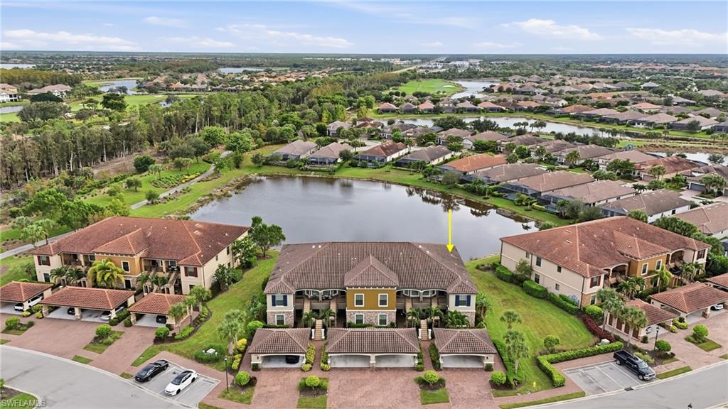 9426 Benvenuto Court, Unit 2104 Naples, FL 34119 - Photo 28 of 45 an aerial view of residential houses and lake view