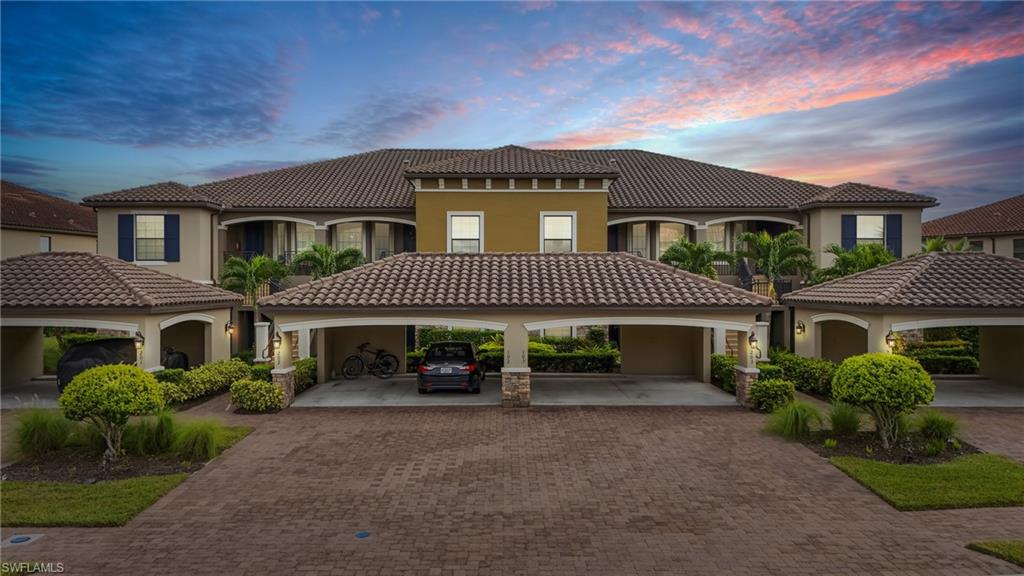 9426 Benvenuto Court, Unit 2104 Naples, FL 34119 - Photo 3 of 45 a front view of a house with a garden