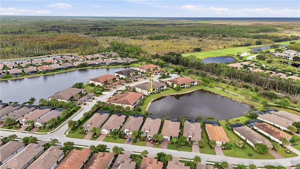 9426 Benvenuto Court, Unit 2104 Naples, FL 34119 - Photo 29 of 45 an aerial view of residential houses with outdoor space and lake view
