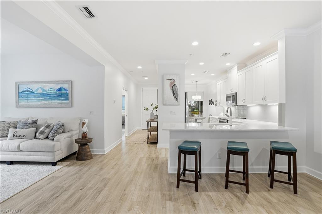 9426 Benvenuto Court, Unit 2104 Naples, FL 34119 - Photo 43 of 45 a living room with furniture and a wooden floor