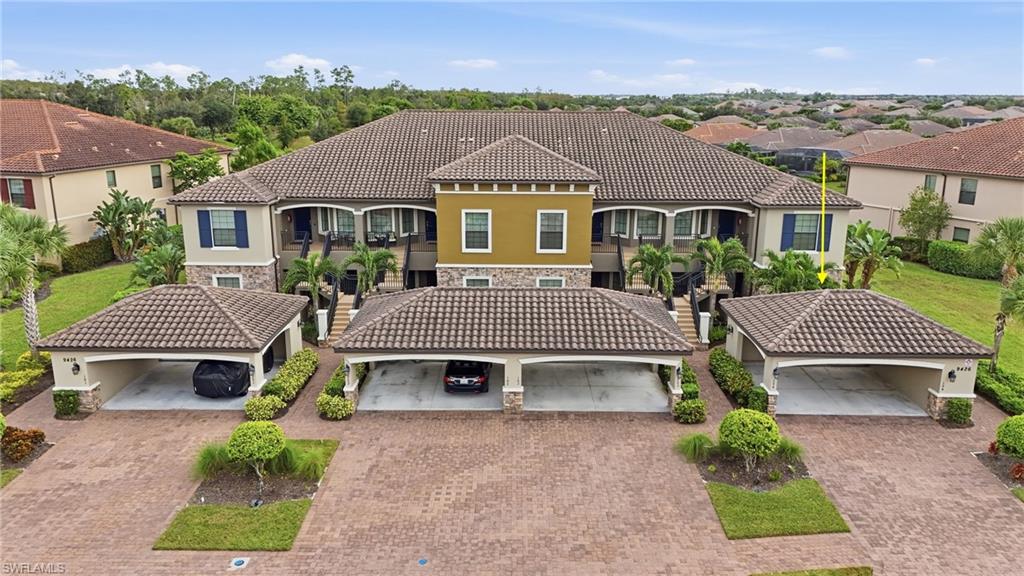 9426 Benvenuto Court, Unit 2104 Naples, FL 34119 - Photo 4 of 45 an aerial view of a house with garden
