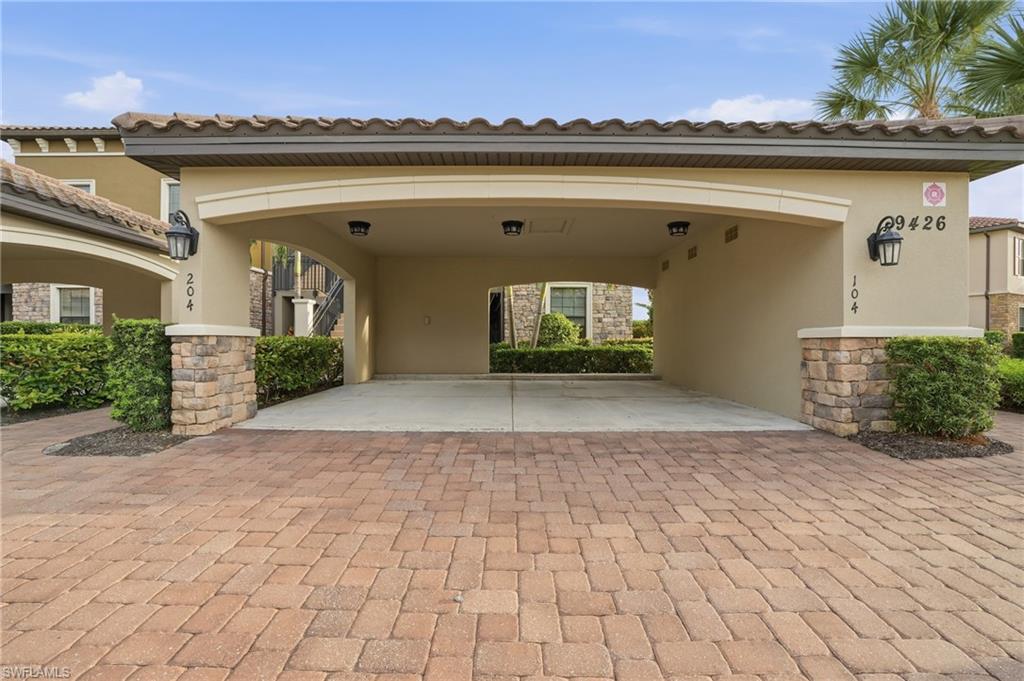 9426 Benvenuto Court, Unit 2104 Naples, FL 34119 - Photo 6 of 45 a view of a building from a yard