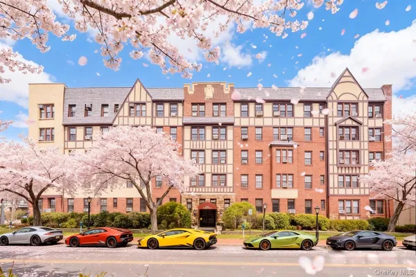a view of a building with cars parked
