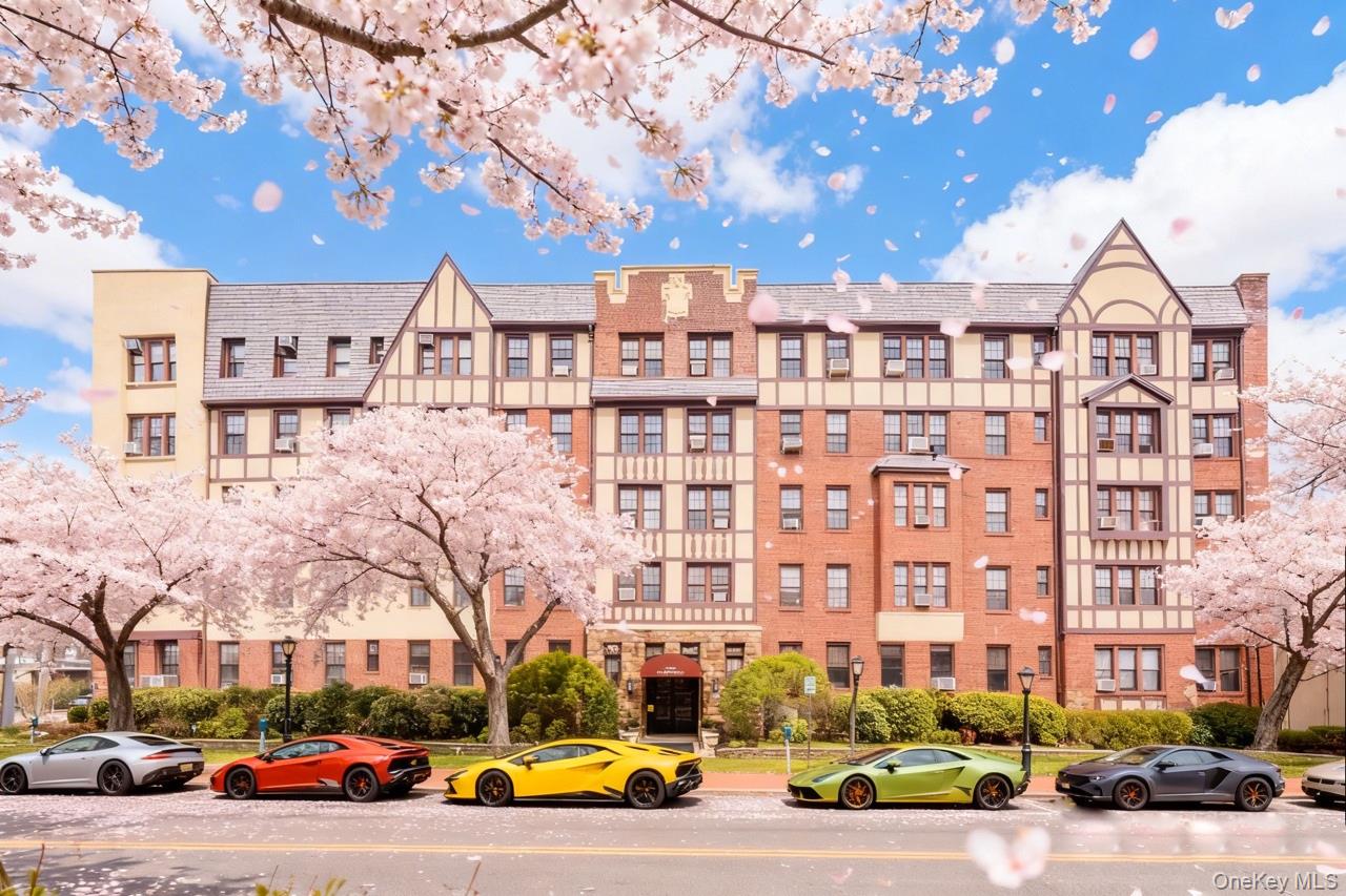 a view of a building with cars parked