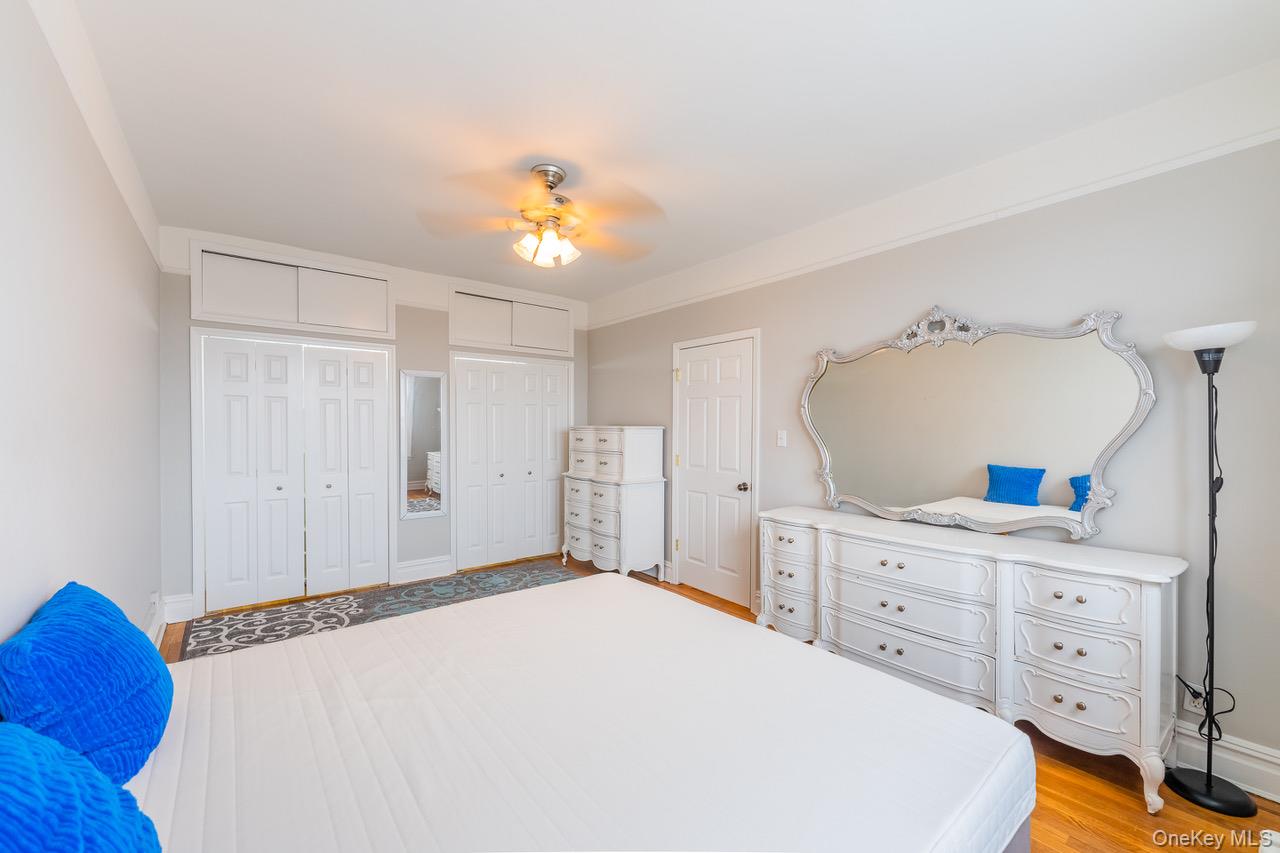 4 Maple Drive, Unit 6O Great Neck, NY 11021 - Photo 17 of 28 a bedroom with a bed and a dresser
