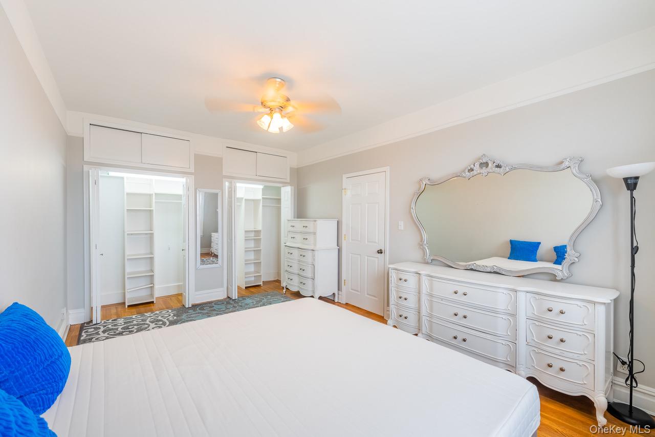 4 Maple Drive, Unit 6O Great Neck, NY 11021 - Photo 18 of 28 a bedroom with a bed and a dresser