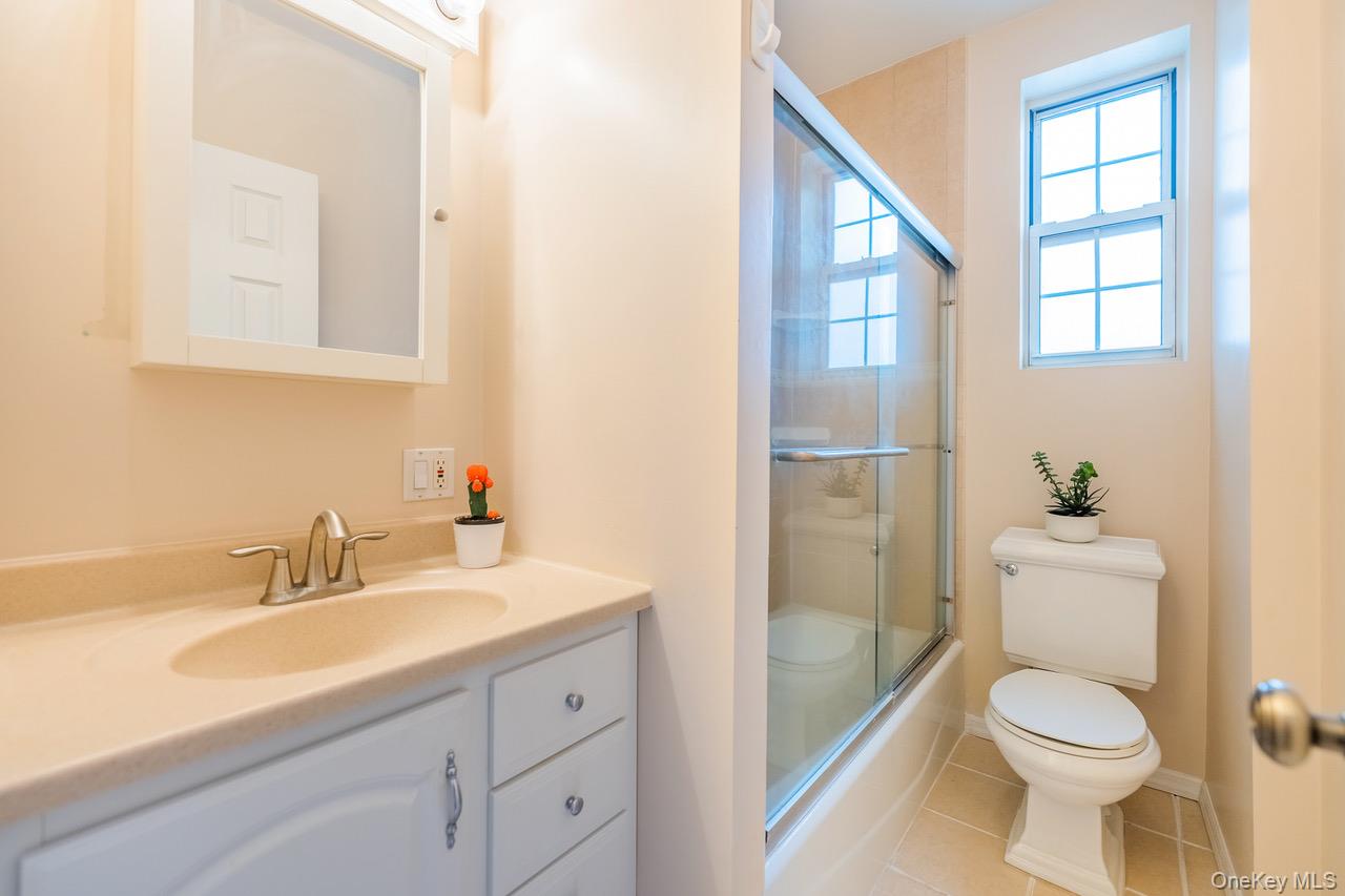 4 Maple Drive, Unit 6O Great Neck, NY 11021 - Photo 20 of 28 a bathroom with a sink a toilet and shower