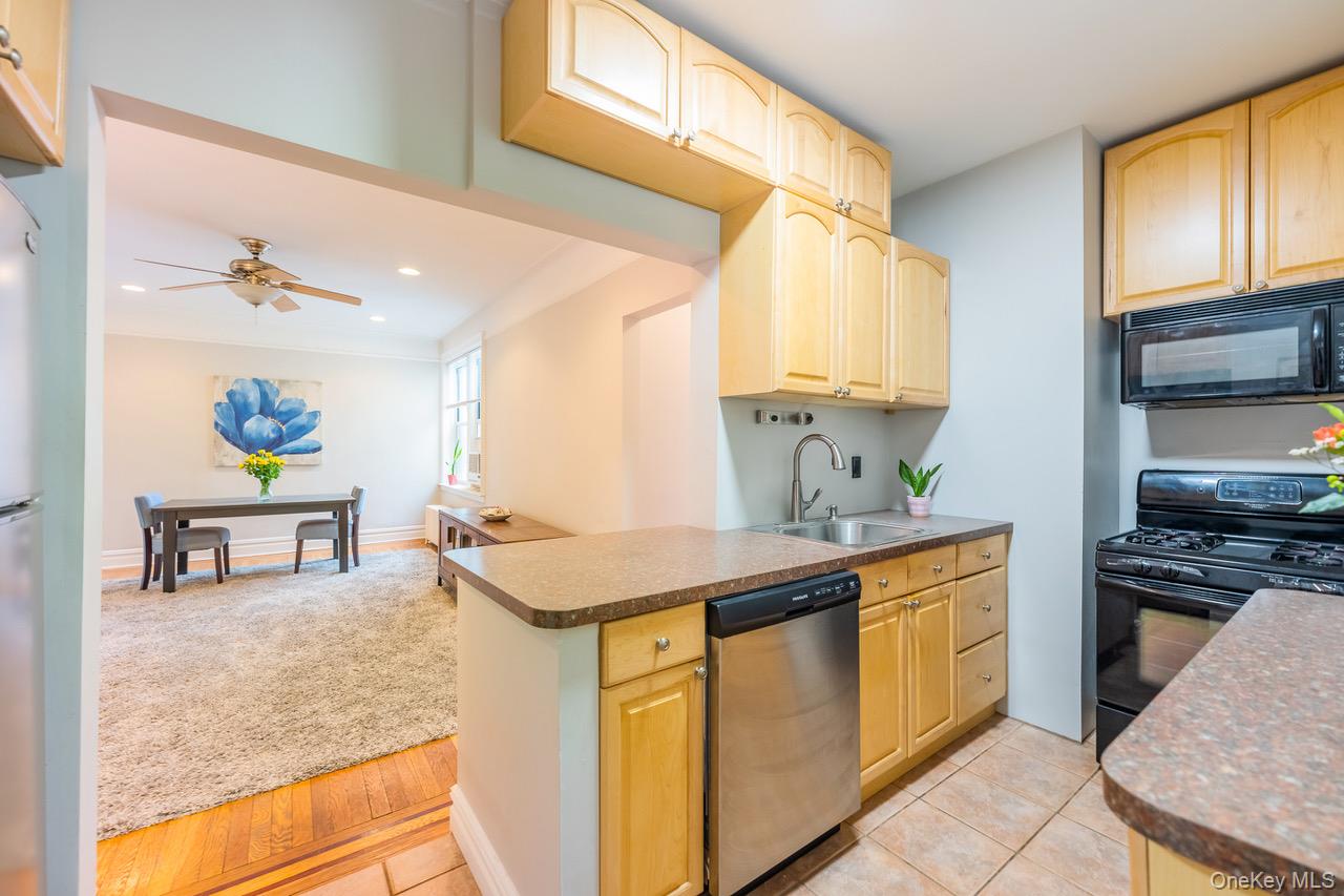 4 Maple Drive, Unit 6O Great Neck, NY 11021 - Photo 8 of 28 a kitchen with stainless steel appliances granite countertop a sink stove and refrigerator