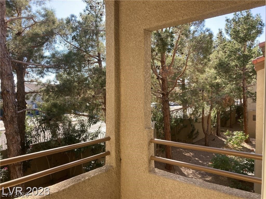 3145 East Flamingo Road, Unit 2100 Las Vegas, NV 89121 - Photo 27 of 34 A tranquil balcony provides a verdant outlook onto mature trees and the neighborhood beyond.