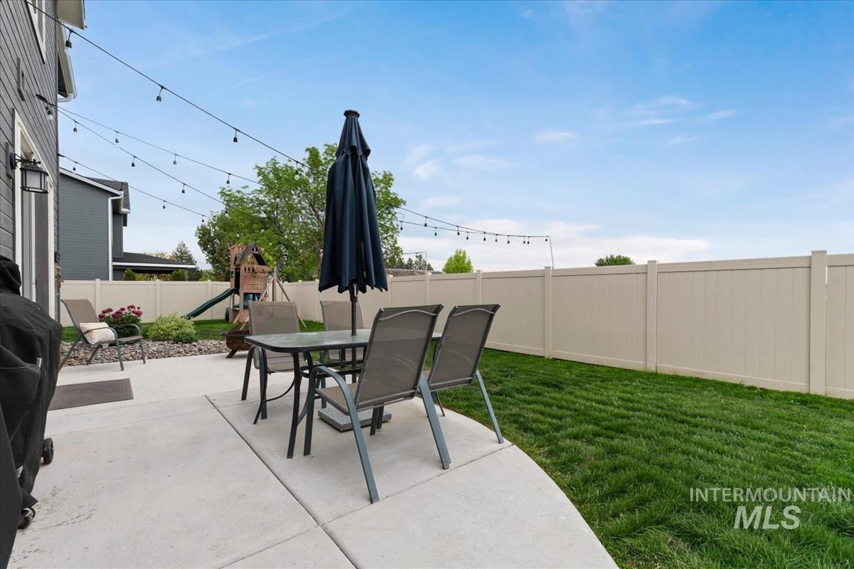 815 Knowledge Street Middleton, ID 83644 - Photo 46 of 49 Expansive concrete patio offering a dedicated outdoor space with string lighting overhead