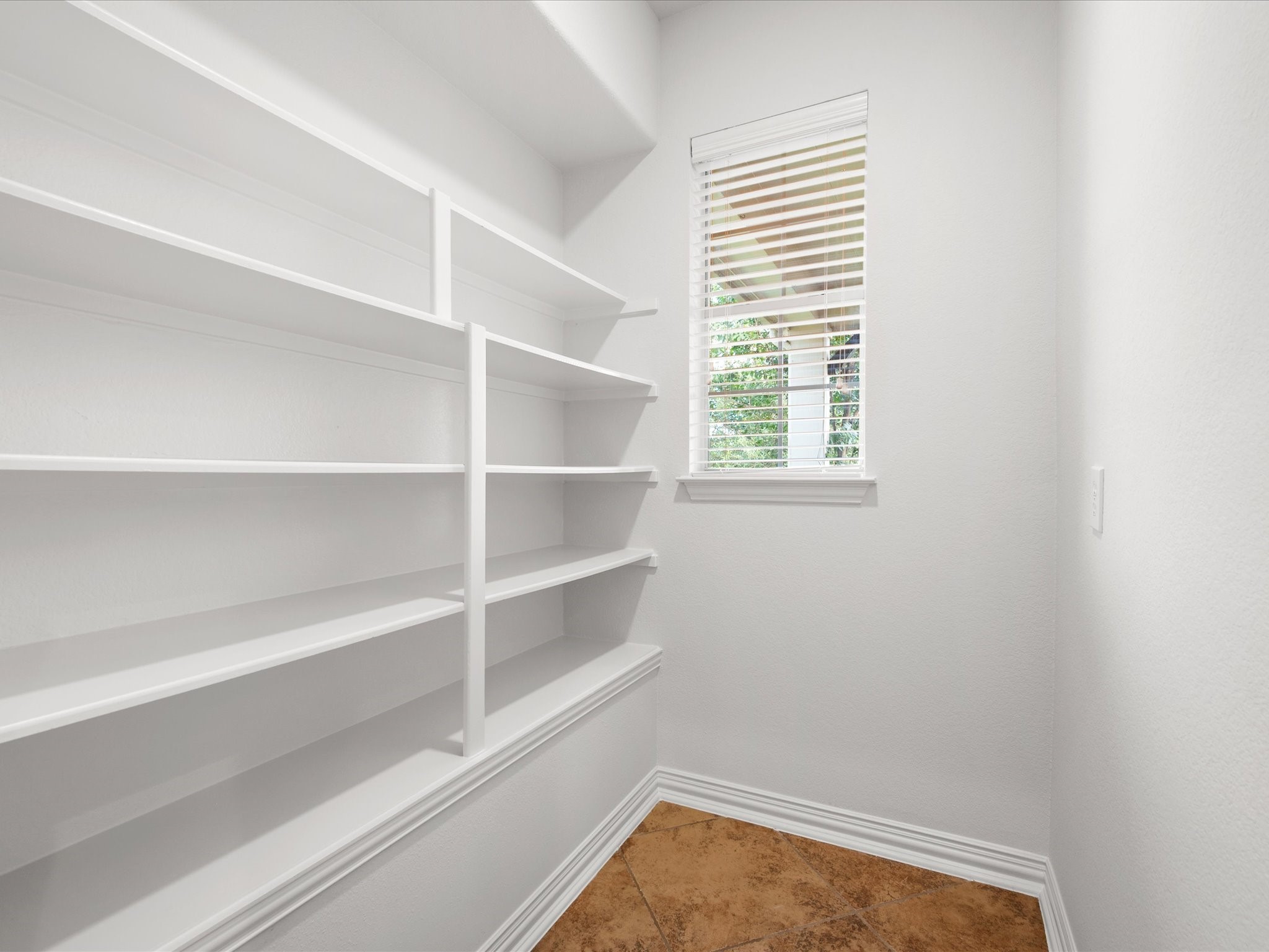 323 Arbor Ridge Lane Conroe, TX 77384 - Photo 12 of 40 Walk. In. Pantry. Floor to ceiling shelving and a window to boot. Costco run? Bring it on. Storage like this is worth its weight in gold.