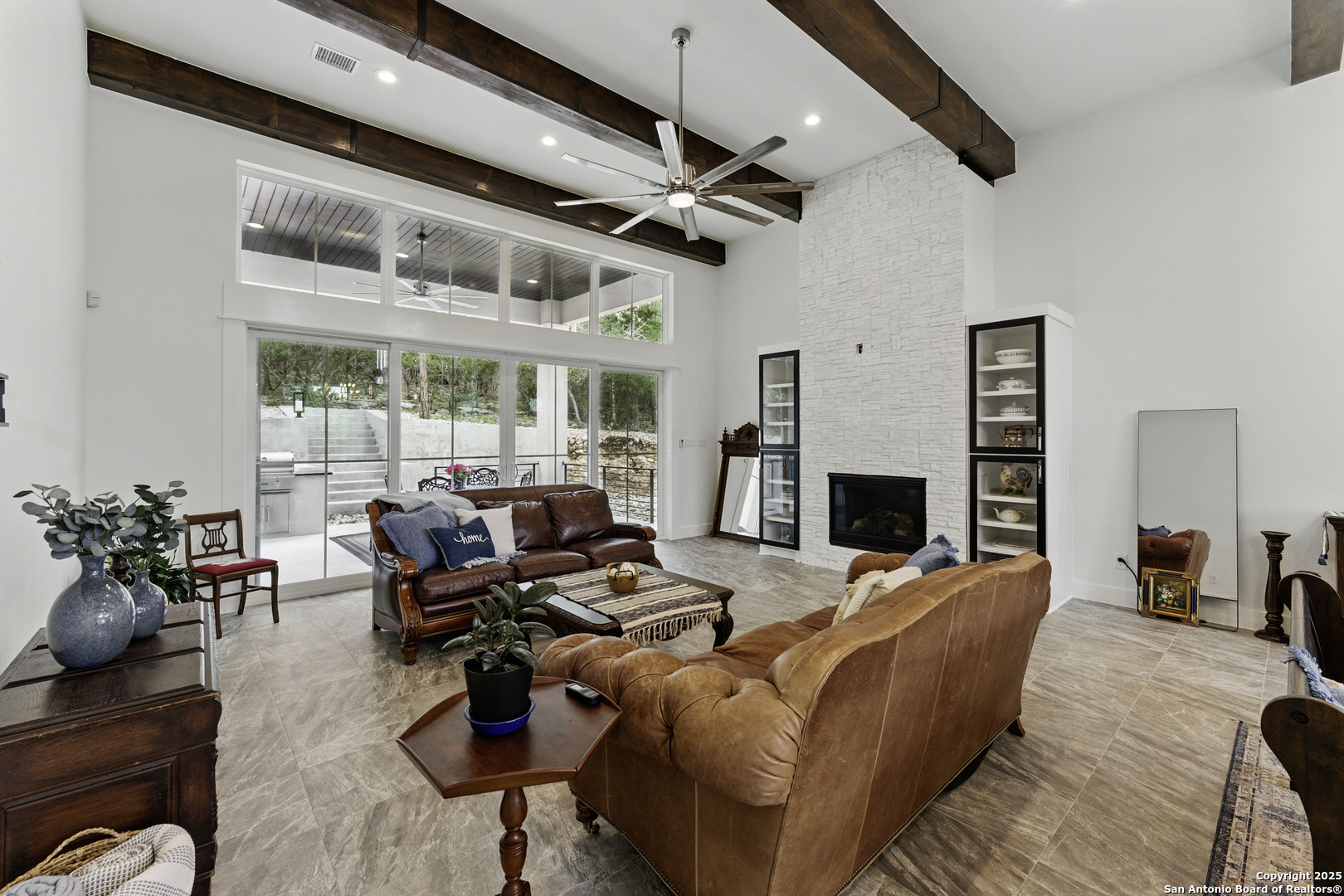 321 Bentwood Drive Spring Branch, TX 78070 - Photo 18 of 50 a living room with furniture a fireplace and a floor to ceiling window