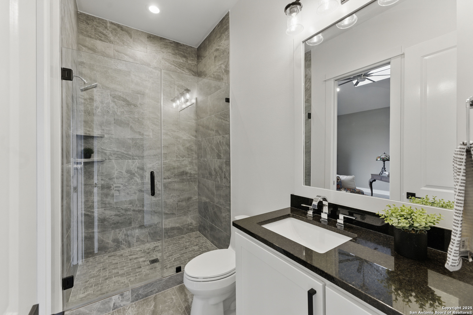 321 Bentwood Drive Spring Branch, TX 78070 - Photo 37 of 50 a bathroom with a granite countertop sink a mirror a toilet and shower