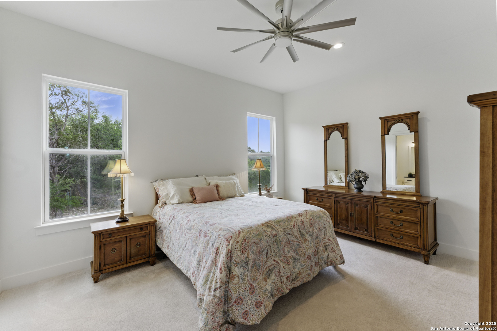 321 Bentwood Drive Spring Branch, TX 78070 - Photo 42 of 50 a bedroom with a large bed and windows