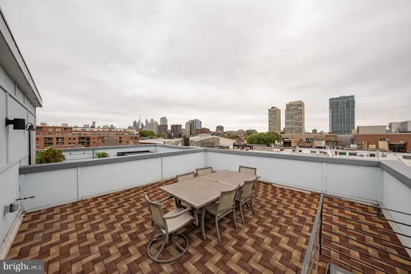 a terrace with outdoor seating city view and barbeque oven