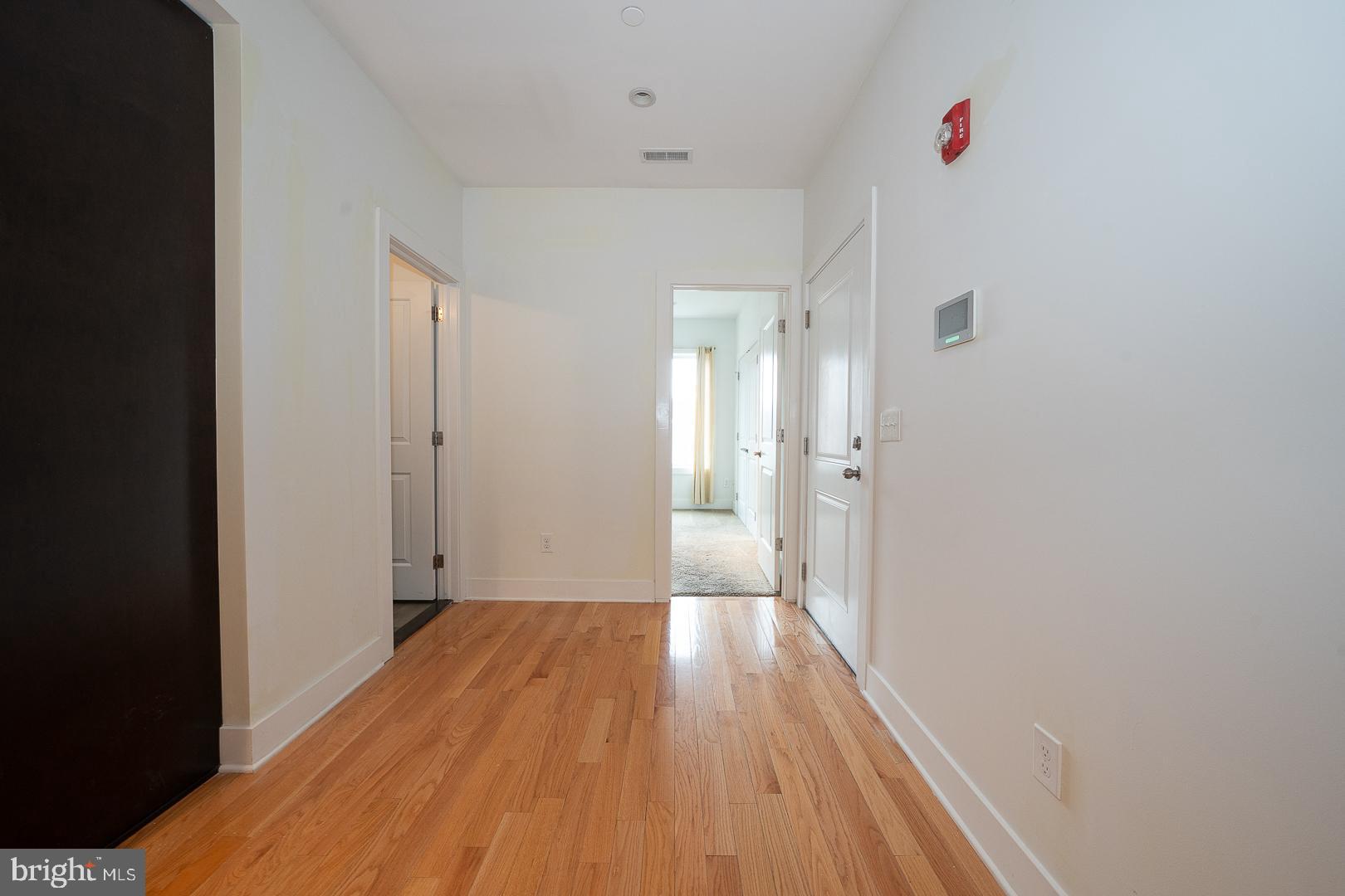 110 Naudain Street, Unit 4 Philadelphia, PA 19147 - Photo 14 of 48 a view of a room with wooden floor and white walls