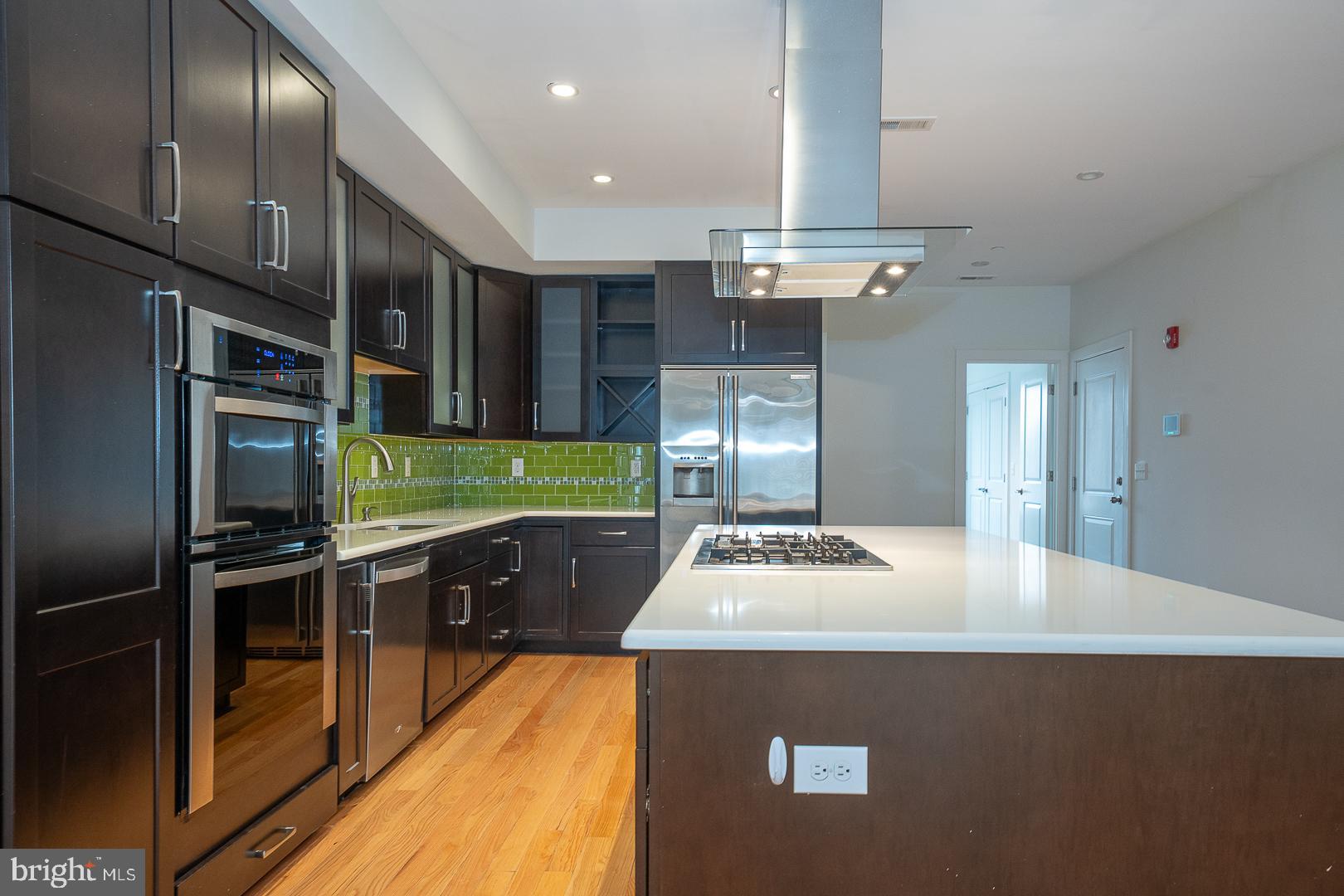 110 Naudain Street, Unit 4 Philadelphia, PA 19147 - Photo 15 of 48 a kitchen with kitchen island granite countertop a sink stainless steel appliances and cabinets