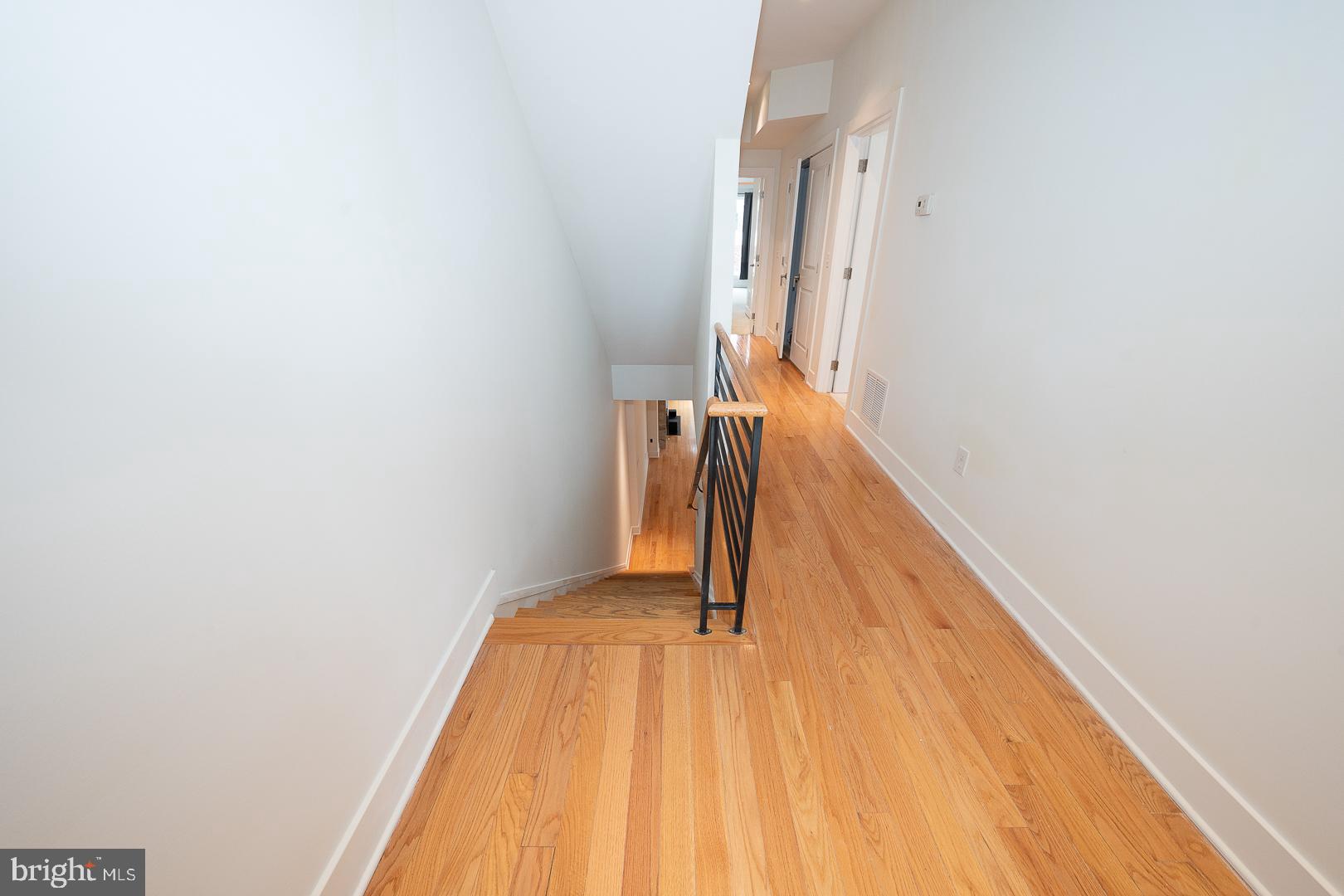 110 Naudain Street, Unit 4 Philadelphia, PA 19147 - Photo 17 of 45 a view of a room with wooden floor and stairs