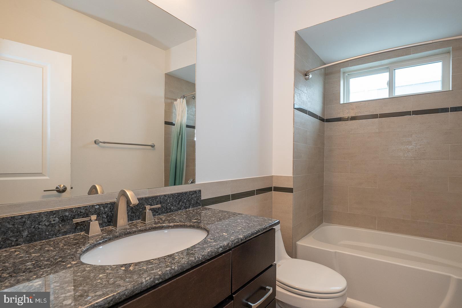 110 Naudain Street, Unit 4 Philadelphia, PA 19147 - Photo 21 of 45 a bathroom with a granite countertop sink toilet and shower