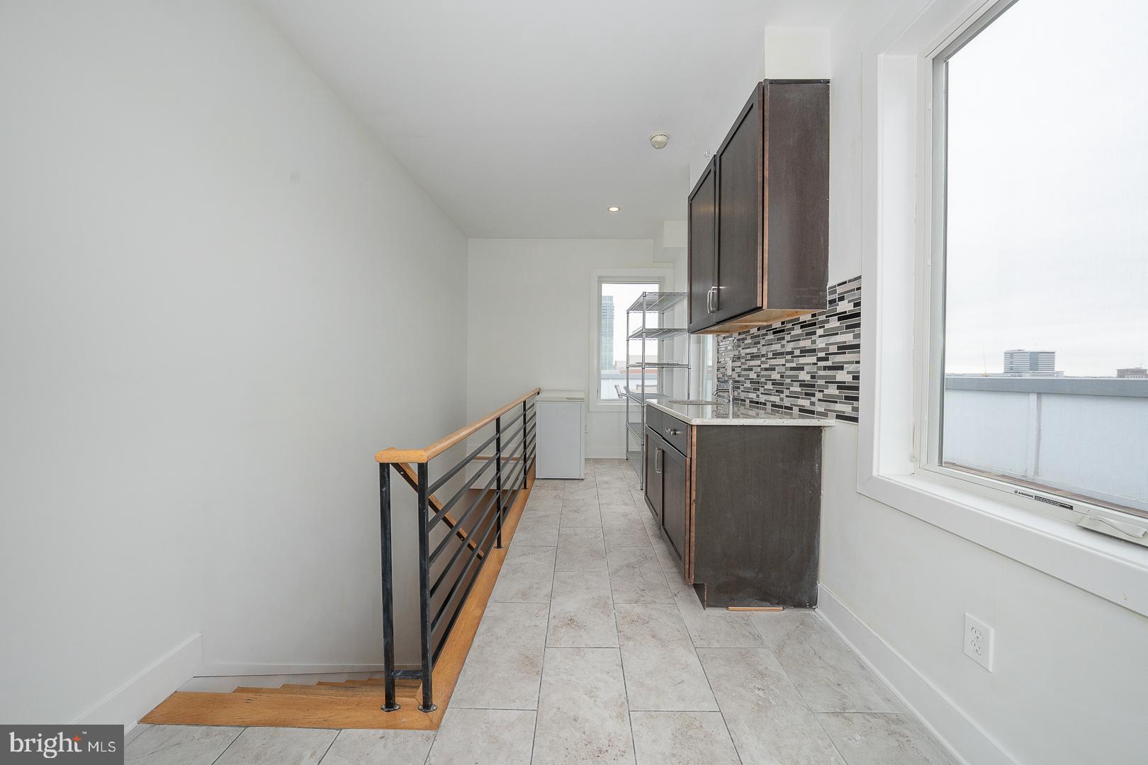 110 Naudain Street, Unit 4 Philadelphia, PA 19147 - Photo 36 of 48 a view of a kitchen from the hallway