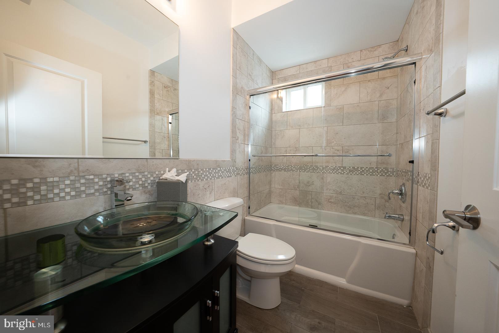 110 Naudain Street, Unit 4 Philadelphia, PA 19147 - Photo 6 of 45 a bathroom with a sink a toilet and shower